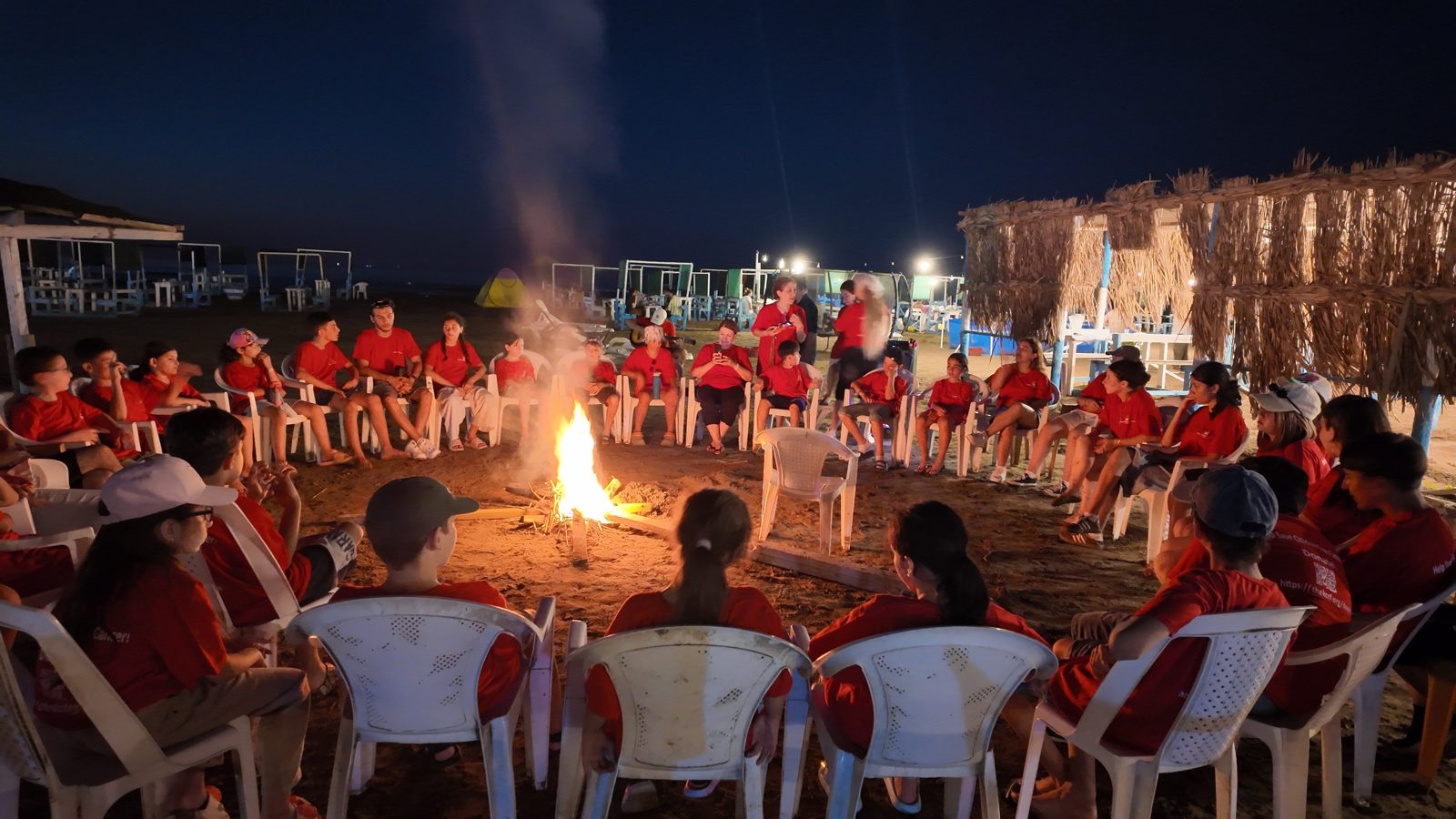 Campers sitting around an evening campfire