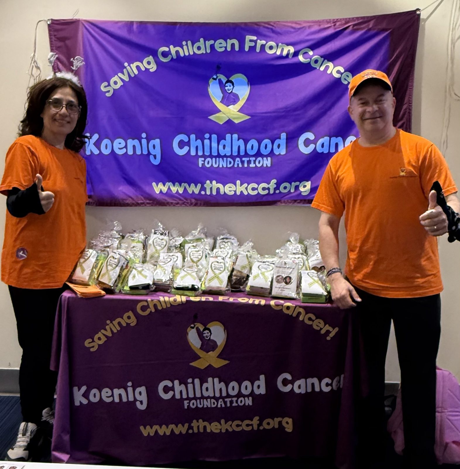 KCCF supporters at a fundraising table with gift bags